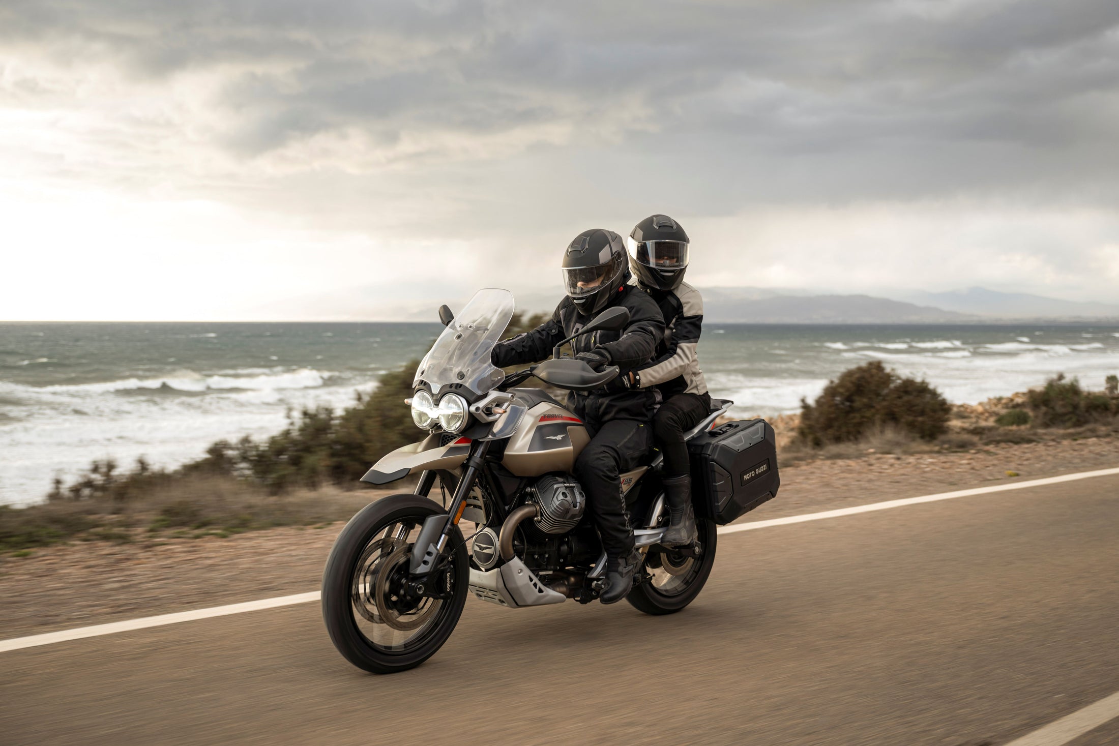 MOTO GUZZI V85 RIDING ALONG A COASTAL ROAD